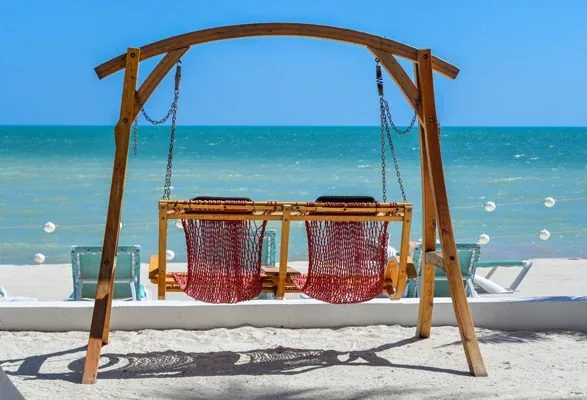 A beach swing facing the turquoise water of the Florida Keys
